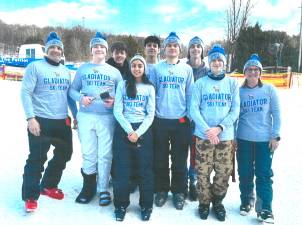 SRO Brandon Raab (left) with coach Kristen Calohan (right) and the high school ski team.