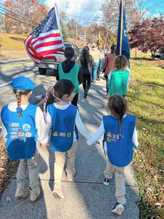 The scouts walking as part of the Veterans Day procession on Nov. 11.