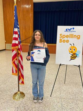 Eighth-grader Cora Massaro stands with her first place certificate.