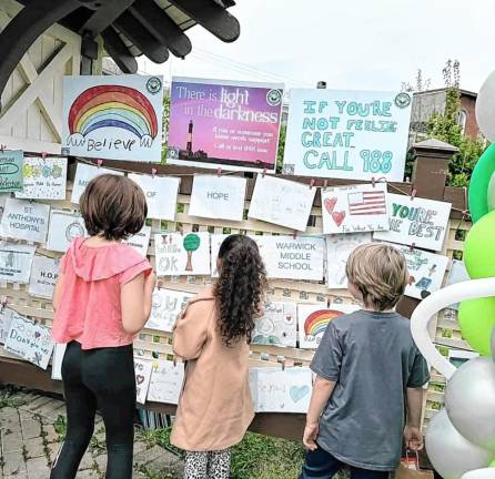 Children read messages of hope at the Warwick Cares mental health awareness event.