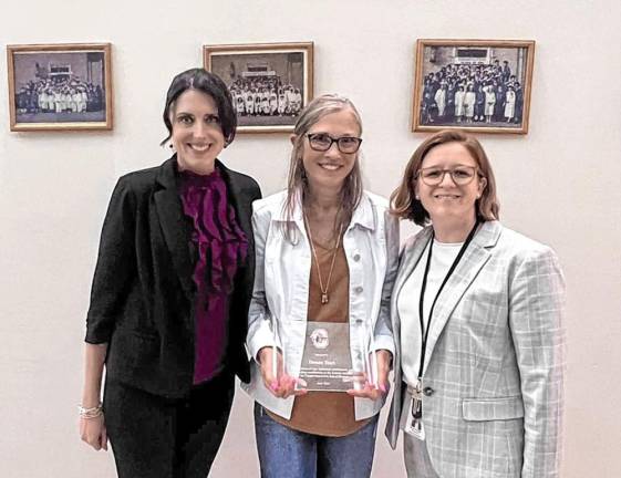 The school district’s Board of Education recently honored special education teacher Donna Hart (center).