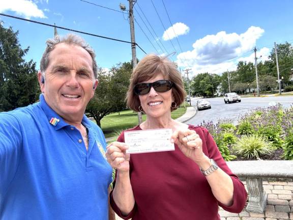 Goshen Rotary Club Vice President Mark Gargiulo presents a check for $500 to co-presidents Marilyn Wolfe and (not in picture) Donna Drybred of the Garden club of Goshen.