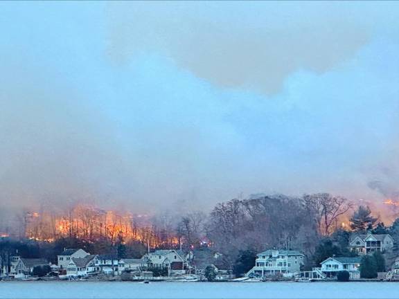 Flames can be seen across Greenwood Lake about 5 p.m. Sunday, Nov. 10. The photo was taken near D’Boathaus on the west side of the lake.