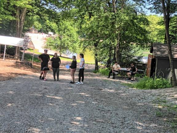 Counselors Mia and Michael Harrison, right, give Cesar and Kenia Gomez and their daughter Kacey, 5, a tour of the Bubbling Springs Day Camp in West Milford.