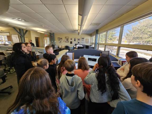 Students gather around Managing Editor Lisa Reider as she writes this article.