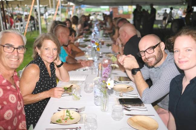 Guests enjoyed their meals at large tables under the tents.