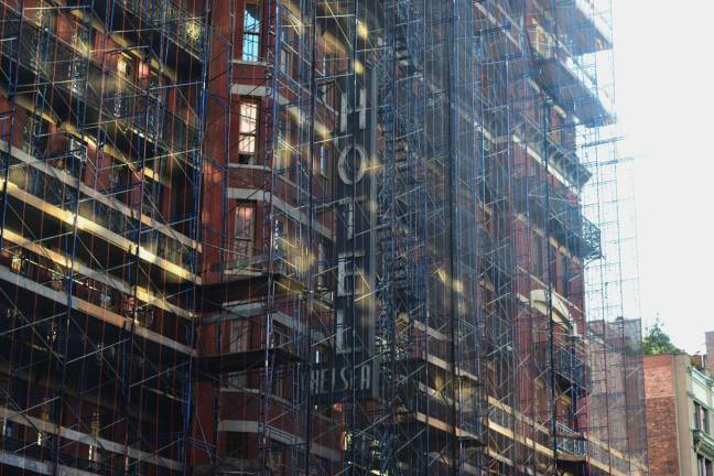 Behind the scaffolding, the old sign for the Hotel Chelsea on West 23rd Street is still visible. Photo: Liz Hardaway