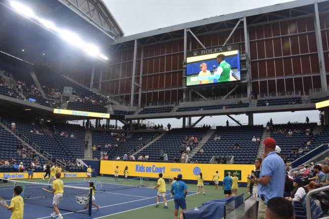 Chase DeSilva, 10, on the big screen while his peers rally in Louis Armstrong Stadium before the evening match.