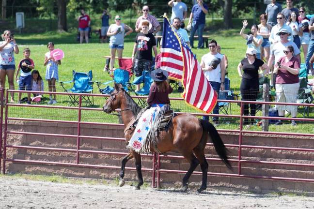 Presentation of “Old Glory” in the arena during the National Anthem prior to the Stampede Bullriding Rodeo.