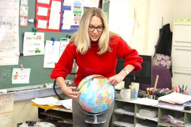 Chester Elementary School teacher Lori Bonito shows her class the distance between New York and Ukraine on a globe.