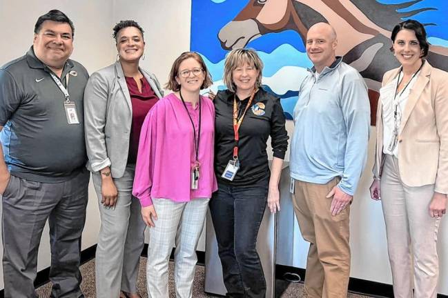 Chester Academy teaching staff celebrate Amy Reid (center, in black), for her award win.