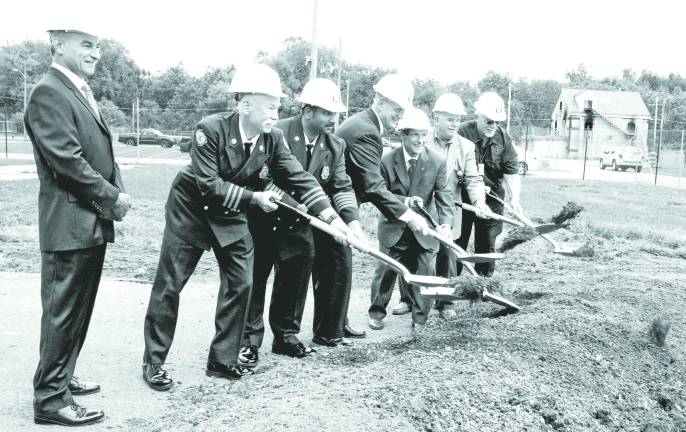 Photo by Ed Bailey Orange County broke ground last week on a new Fire Training Center burn building at the County&#xed;s Fire Training Center in New Hampton. Pictured are: Emergency Services Commissioner Walter Koury, Fire Training Center Manager Jim McCann, Deputy Commissioner for Fire Services Vini Tankasali, Public Works Commissioner Charles Lee, Orange County Executive Edward A. Diana, Legislative Chairman Michael Pillmeier and Fire Advisory Board Chairman Lee Gerow. The current burn building can be seen in the background on the right.