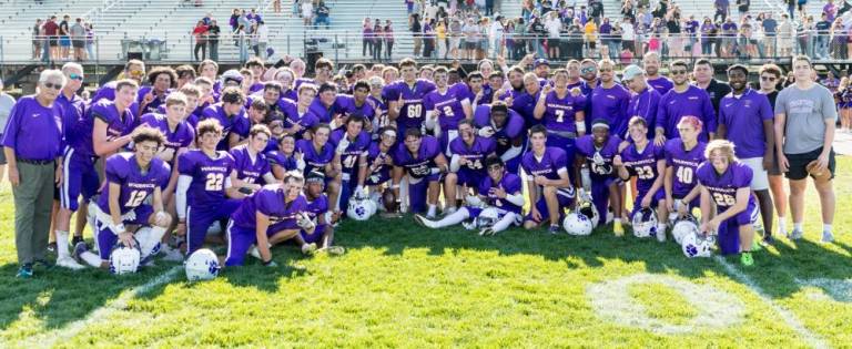 Grant Havel, #56, holds the Spirit trophy following the game on Saturday, September 21.